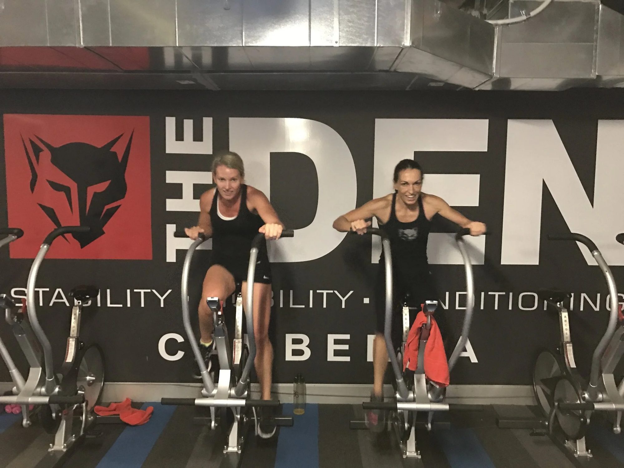 Members training in front of the Den wall